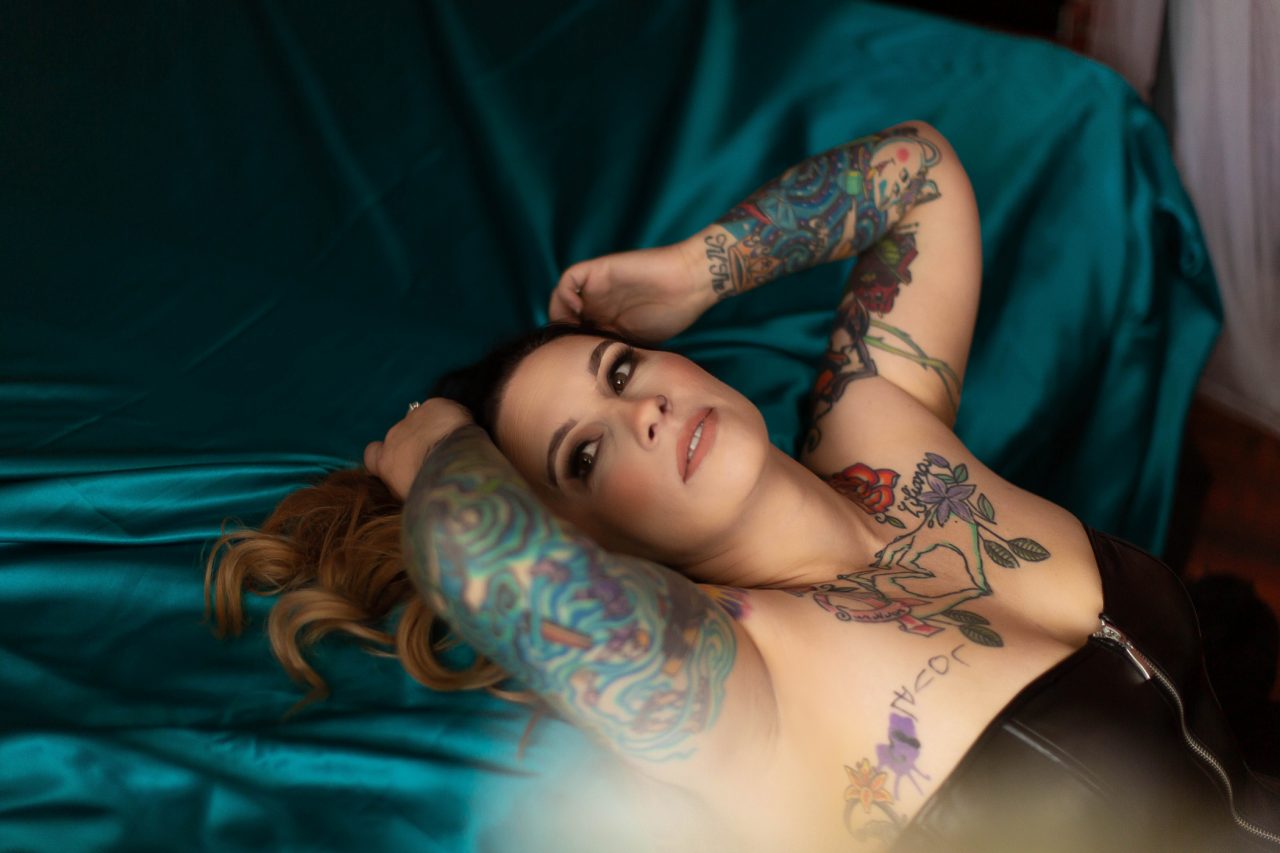 Beautiful brunette with tattoos posing for a boudoir photography session with Boudoir by Cipriani in Tampa, FL