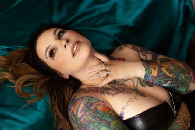 Brunette with tattoos posing for a boudoir photo session with Boudoir by Cipriani, Tampa, FL